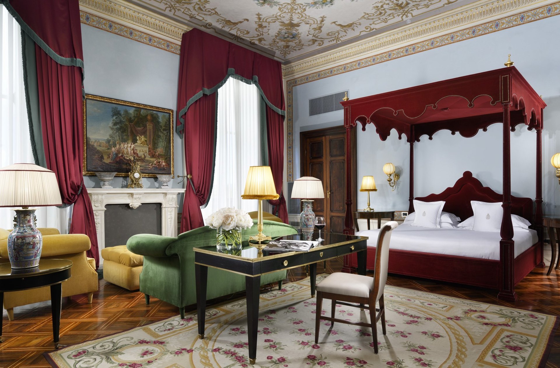 A suite at Villa Cora, with a red four-poster, a painted ceiling and green velvet sofas