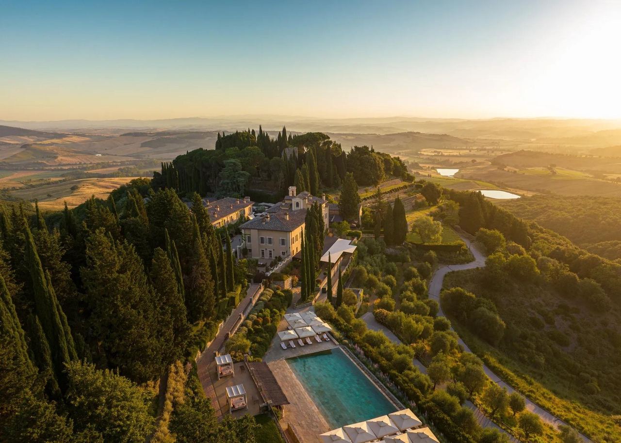 Castiglion del Bosco from the air at sunrise, with its pool above the Val d’Orcia